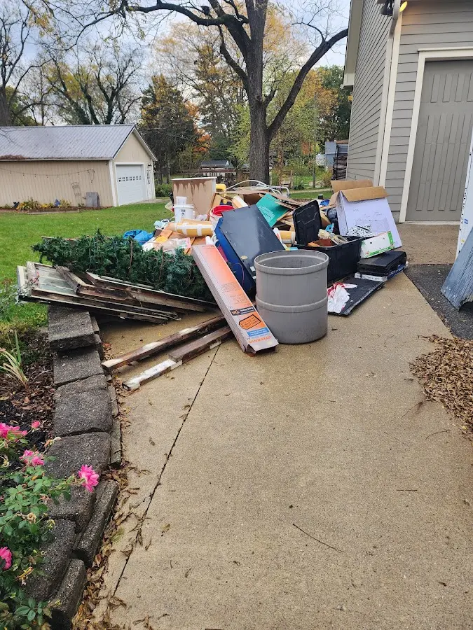 Dumpster being loaded with debris for 3 Yard Dumpster Rental in Fairburn